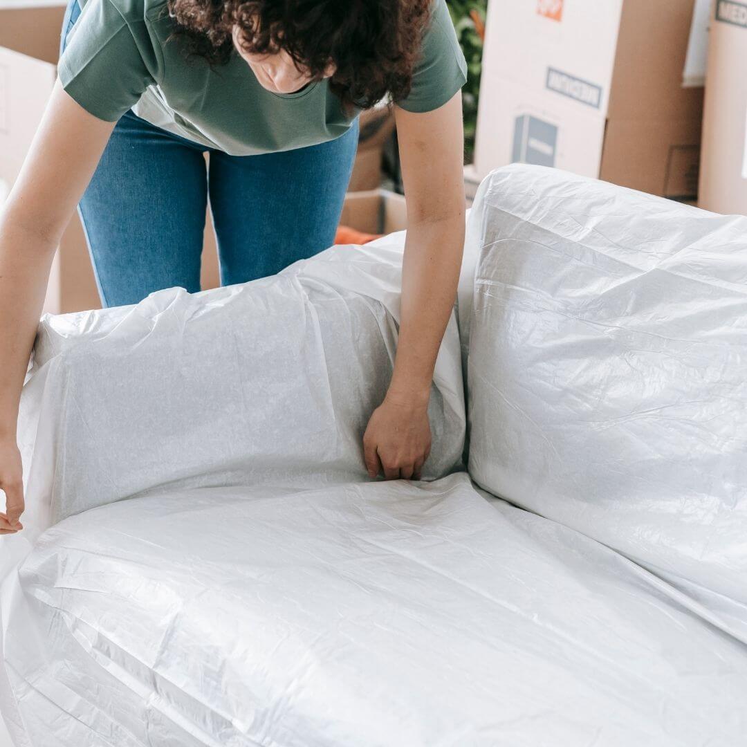person packing a couch