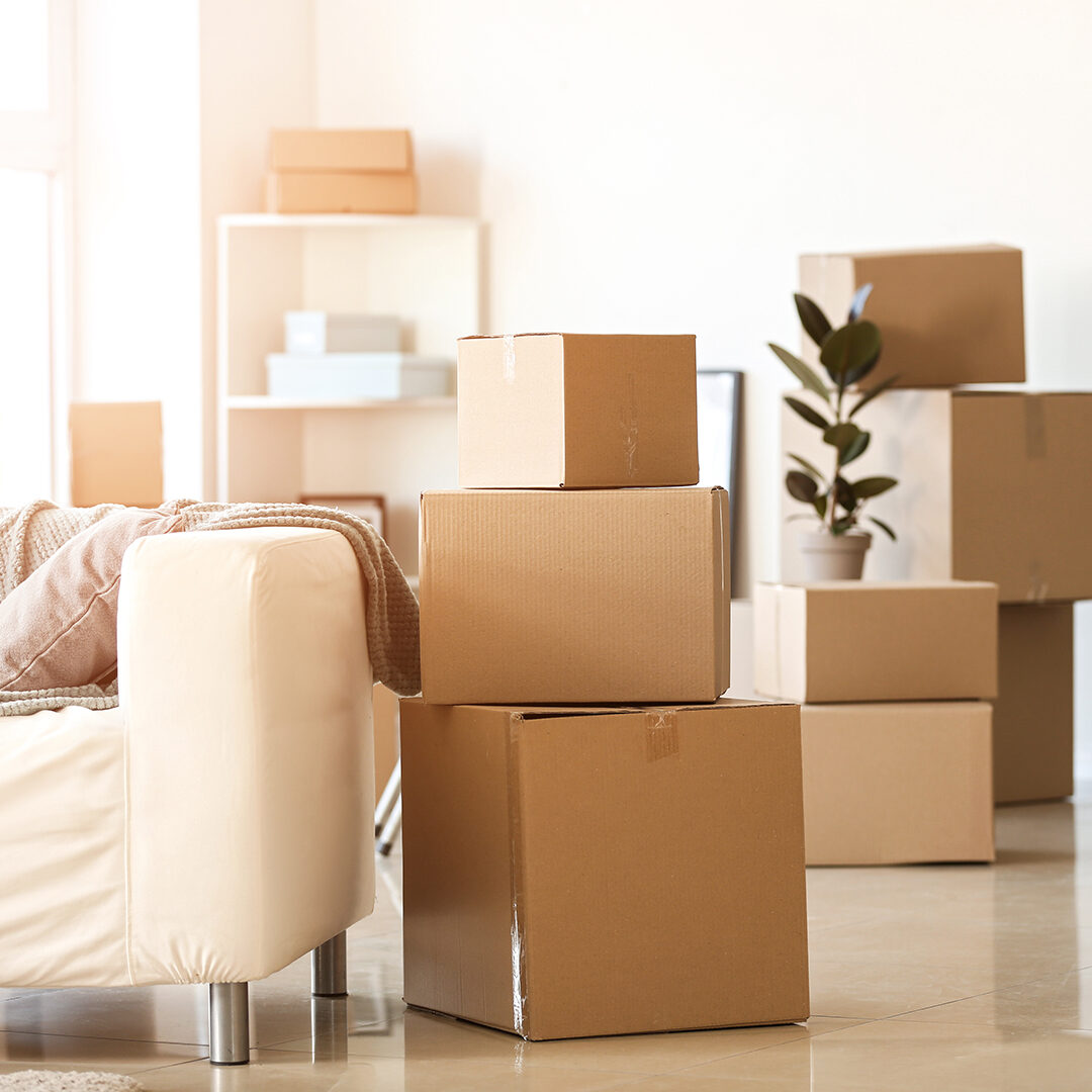 Moving boxes with belongings in room