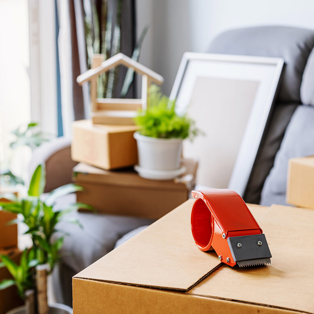 Stack of cardboard boxes in living room at new house on moving day