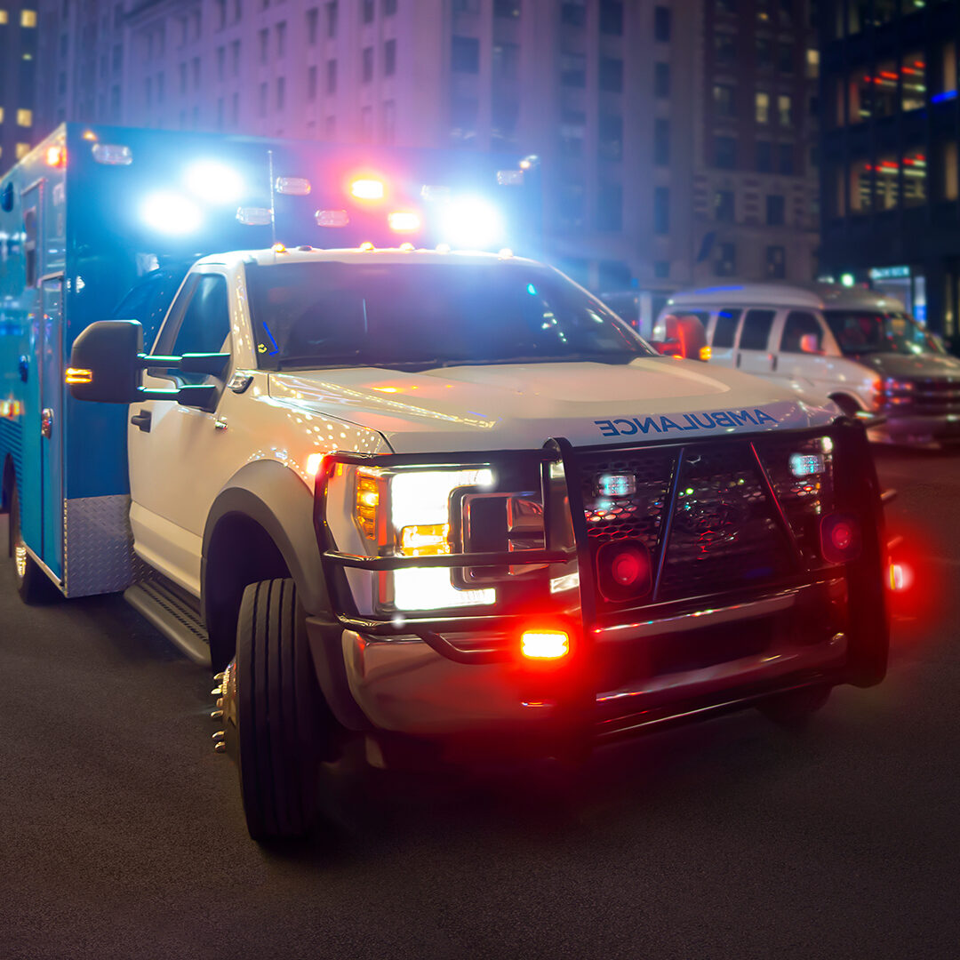 Night ambulance with lights flashing on a new york city street