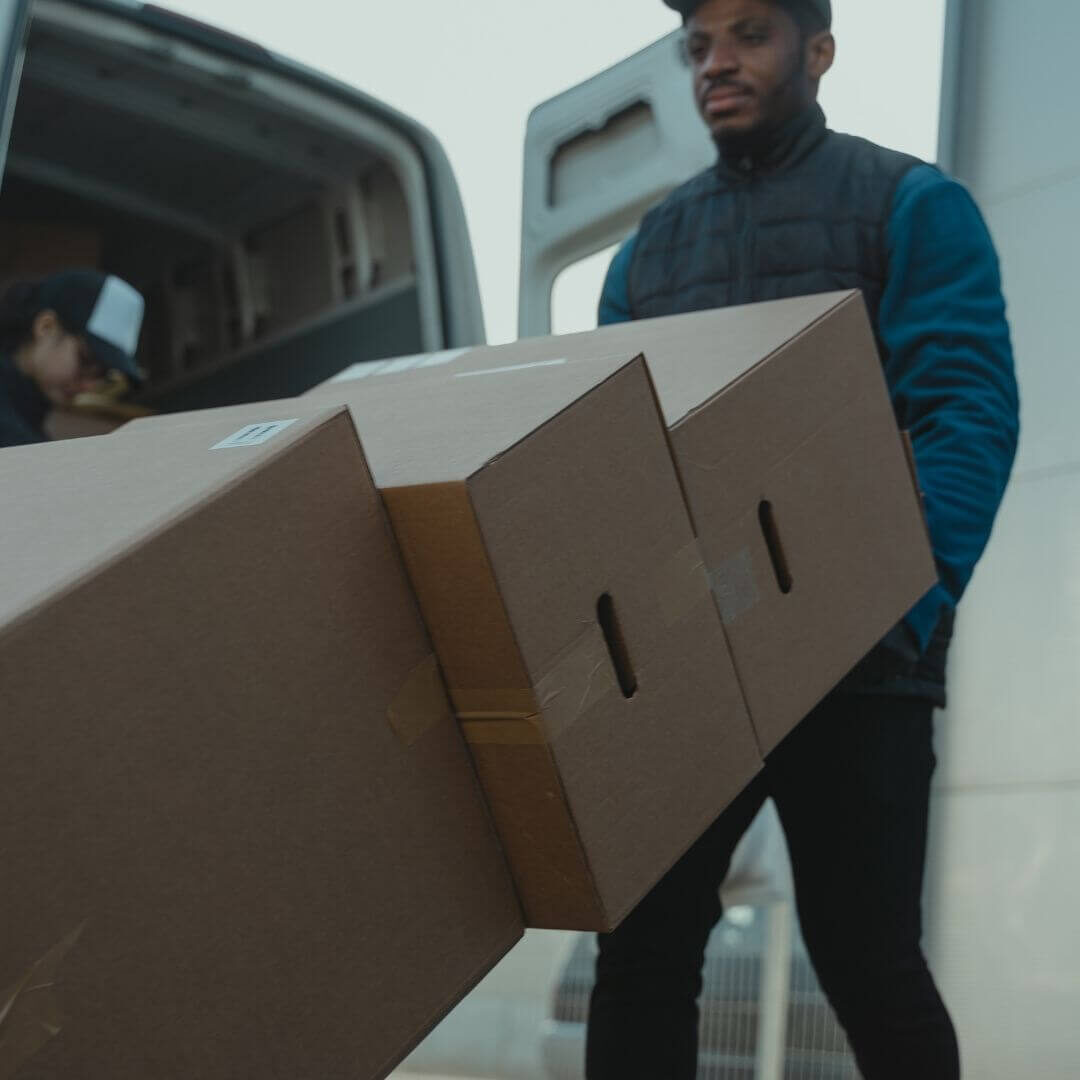 mover using a handcart to move boxes